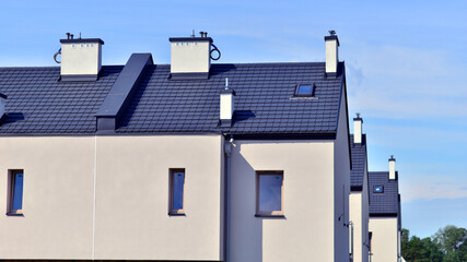 Terraced residential homes with modern facade in newly developed housing estate. The real estate market in the suburbs. New terraced houses in a new development area.