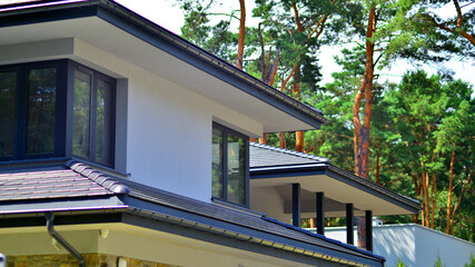 Obraz premium Upscale house in wooded area. Fragment of a single-family house facade. 
