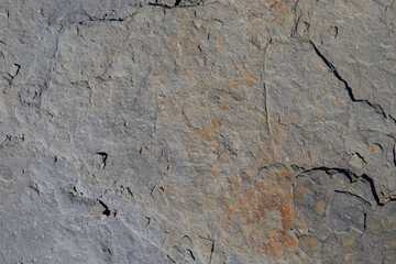 Sea-worn stone texture on a wild coastal beach.
