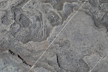 Sea-worn stone texture on a wild coastal beach.