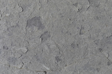 Sea-worn stone texture on a wild coastal beach.