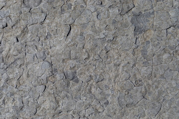 Sea-worn stone texture on a wild coastal beach.