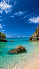 Naklejka premium Stunning tropical beach with clear turquoise water and rocky cliffs under a bright blue sky. Perfect for travel and vacation themes.