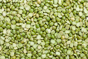 Uncooked, split, green peas background. Dry peas grains. Top view