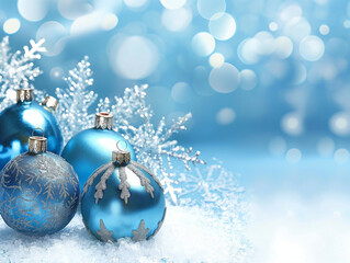 Blue christmas baubles on shiny and snowy winter background. Blue and white colors. Copy space.