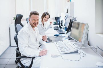 two doctors man and woman doctor examine an MRI image of the brain in an MRI room. Blurred image	