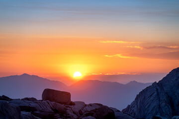 Sunrise on the Mt. Whitney Trail with rocks silhouetted in the foreground