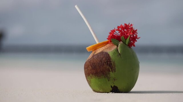 Tropical cocktail in a coconut on a beautiful beach, paradise, exotic holiday, white sand, ocean, horizontal video