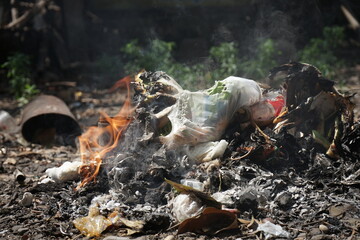 household waste is burned and emits white smoke. air pollution