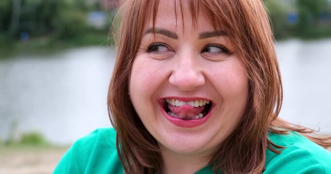 Make eyes red hair dentistry beautiful teeth Different emotions of a woman, a plump woman opens her mouth, does lip exercises, licks her teeth, blinks, smiles