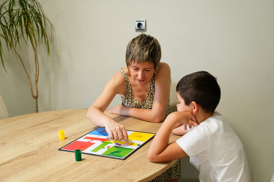 Mother and son sharing a joyful moment over a board game