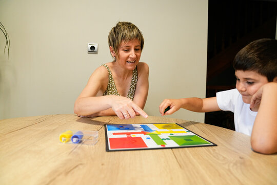 Mother and son having fun playing a board game together