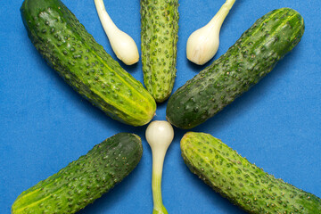 Green onion and cucumbers on blue background	