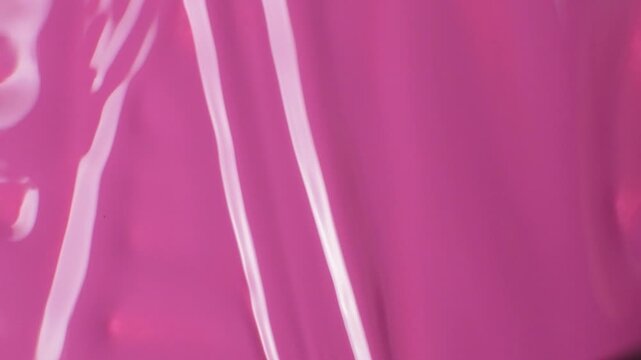 Brush stroke on pink nail polish, macro texture of polish