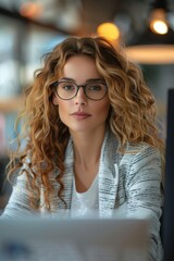 Professional Woman with Curly Hair and Glasses Working in a Modern Office Environment