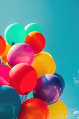 Colorful Balloons Floating in Blue Sky. Vibrant Celebration Image