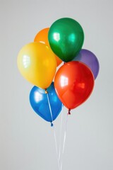 Vibrant Cluster of Colorful Balloons Against White Background