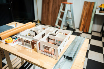 A model of a house showing various rooms such as bedrooms, bathrooms, kitchens, and living rooms,...