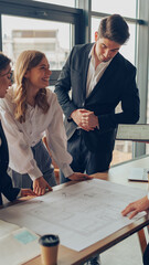 Group of professional team design engineers working with project documents in modern office