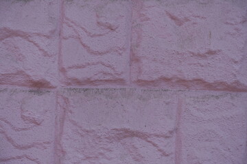 Close view of painted pink masonry veneer wall