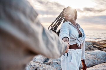 Couple, beach and holding hands for support in outdoor, trust and romance in relationship. Happy people, ocean and nature for love in marriage, together and travel for peace by sea for affection