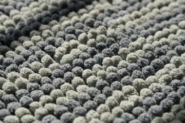 Closeup navy and grey color fluffy doormat with fur of pet in sunlight. Cleaning and hygiene house concept. Surface and texture background.