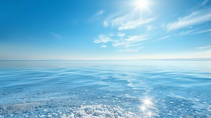 Obraz premium Serene Lake Salt Scenery, Tranquil Waters and Sky, Salt Crystals on Surface, Horizon in Distance, Bright Sunlight - Ideal for Atmosphere of Tranquility and Simplicity, Clarity in Light Blue