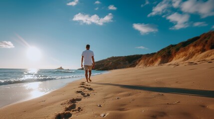 Naklejka premium Lonely man walking on the beach leaving footprints