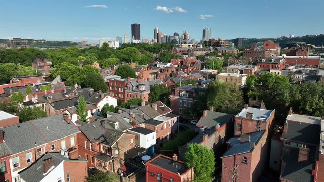 Historic brick rowhouses in Pittsburgh neighborhood. Aerial view of housing near downtown city in Pennsylvania during summer.