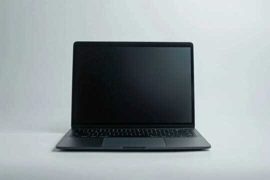 An isolated black laptop placed against a plain white background with its screen turned off, emphasizing minimalistic design and modern tech aesthetics.