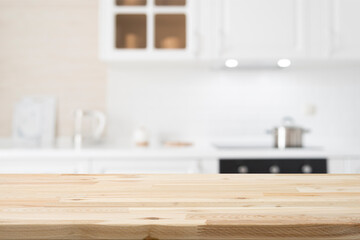 Wooden table top on white and bright modern kitchen interior background