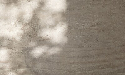 Fototapeta premium Close up of blank gray stone rock wall with dapple sunlight and shadow for modern product background, interior and exterior design decoration 3D