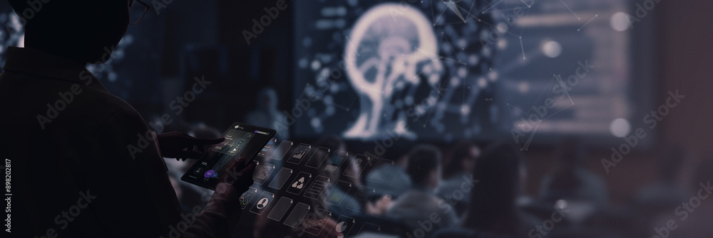 Aufkleber person interacts with a digital tablet displaying medical data while a holographic brain projection is shown in the background at a conference