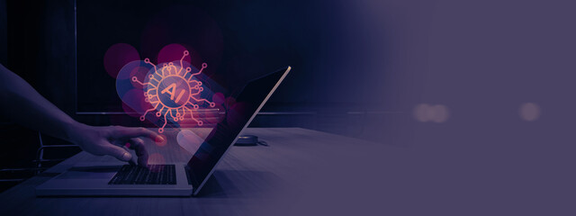 hand reaches out to touch the keyboard of a laptop displaying an AI hologram on its screen. The...