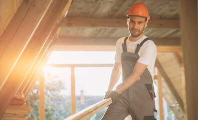 Process of construction new and modern modular house. Worker man in special protective uniform wear working on building development industry of energy efficient property.