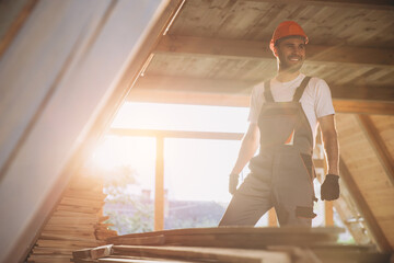 Process of construction new and modern modular house. Worker man in special protective uniform wear working on building development industry of energy efficient property.