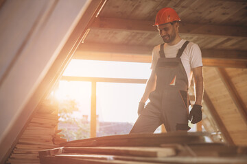 Process of construction new and modern modular house. Worker man in special protective uniform wear...