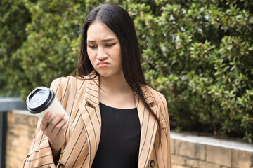 Unhappy and angry office worker woman not feeling satisfying after tasting bad tasteless coffee or...