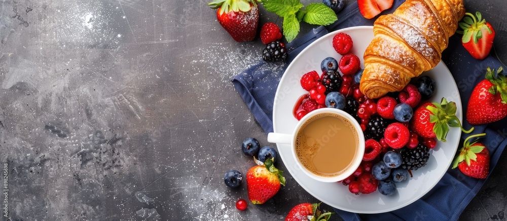 Poster top view of a breakfast themed image featuring fresh berries a croissant and coffee designed with sp