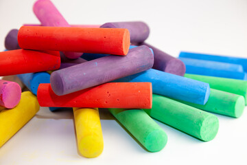 Set of colorful chalks for the board and the street. Drawing chalk stick, back to school background. Heap draw equipment.