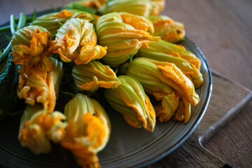 zucchini flowers on a wooden natural background