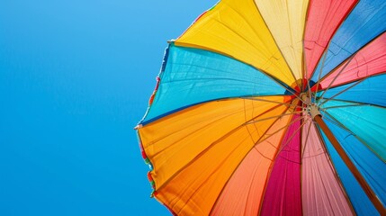 Colorful Beach Umbrella Against Blue Sky.