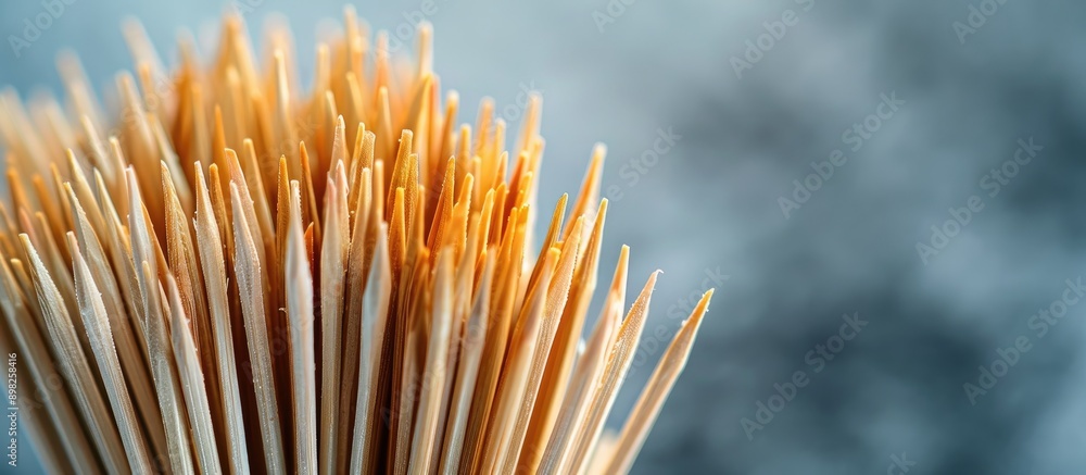 Fototapete Close up macro shot of sharp toothpicks arranged uniquely against a grey backdrop with ample copy space image