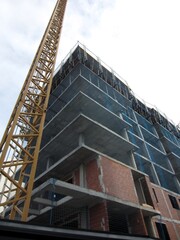 block of flats in construction with crane