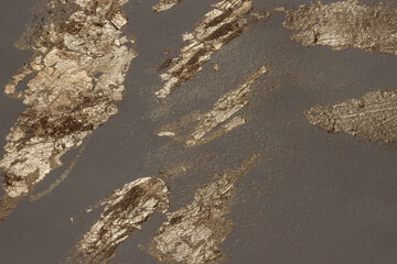 Gold glitter sparkles on dark watercolor paper