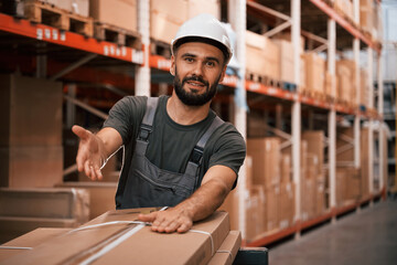 Showing packages by hand. Foreman is in the storehouse, shipping distribution business