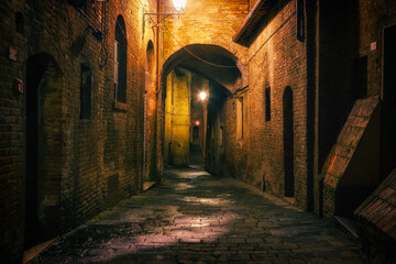 Obraz premium Narrow street in old town Siena at night, Italy
