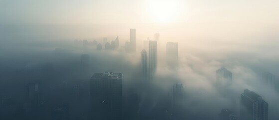 Fototapeta premium Cityscape with skyscrapers emerging from thick fog at sunrise.