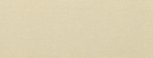 Texture of light beige color background from textile material with wicker pattern, macro. Vintage sand fabric