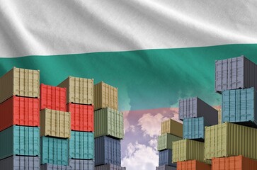 Bulgaria flag and big stack of shipping cargo containers in docks with sky background close up